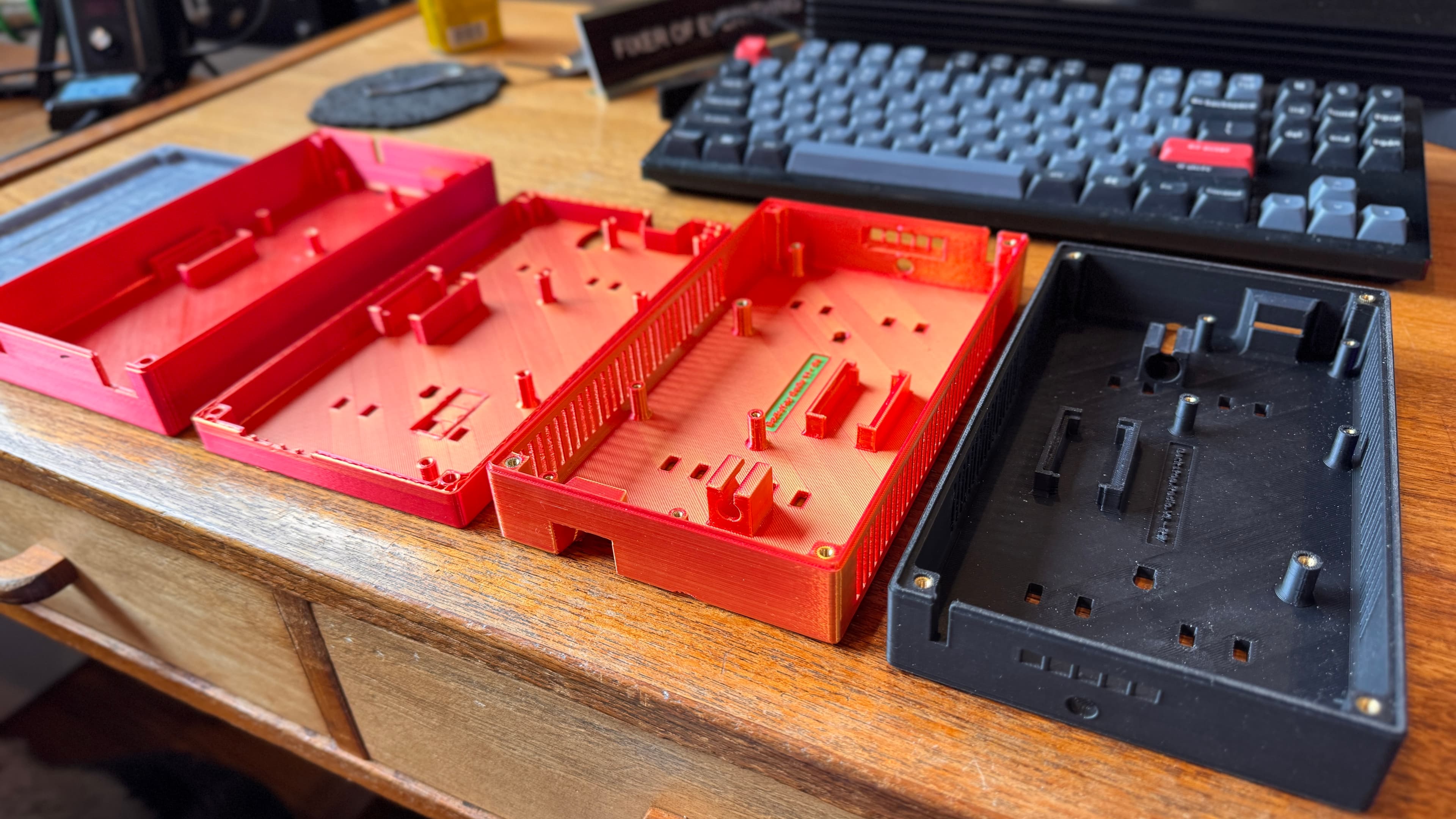 Over thirty 3D-printed enclosure prototypes showing iterative design